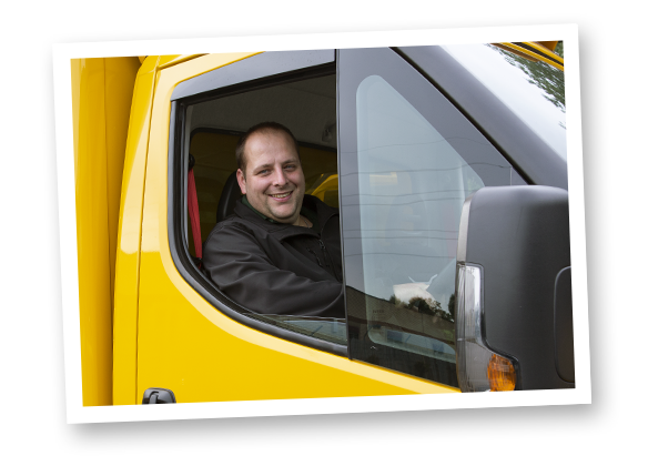 A photograph of an Abel & Cole delivery driver in an Abel & Cole yellow van